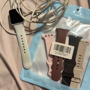 Apple Watch with White Band and Extra Pink, Brown, Black, Beige Silicone Bands